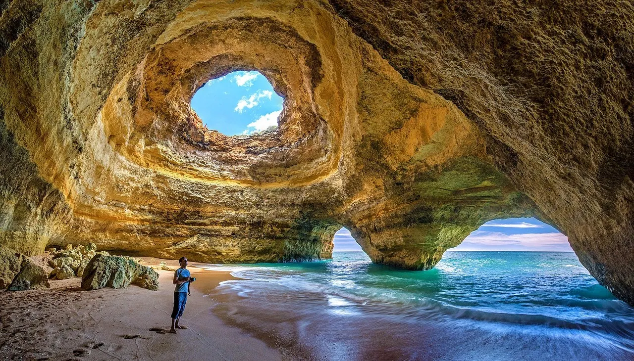 Benagil-grot in de Algarve met opening in het dak, zandstrand en turquoise zee