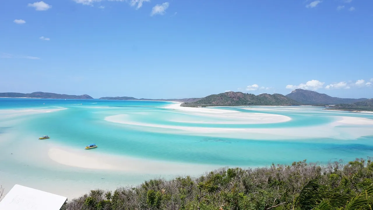 Uitzicht over de wervelende witte zandbanken en het turquoise water van Hill Inlet bij Whitehaven Beach