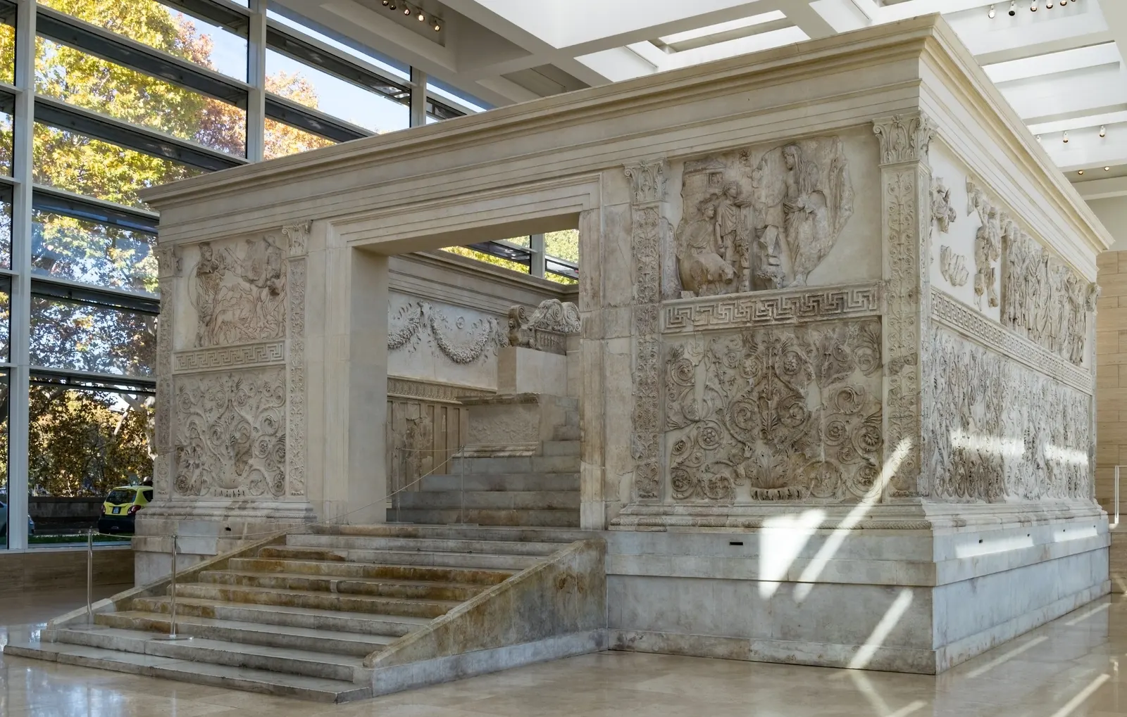 Het marmeren Ara Pacis-altaar met rijk versierde reliëfs en trap in het lichte museum in Rome
